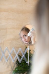 A-photo-of-a-woman-applying-cream-on-her-face