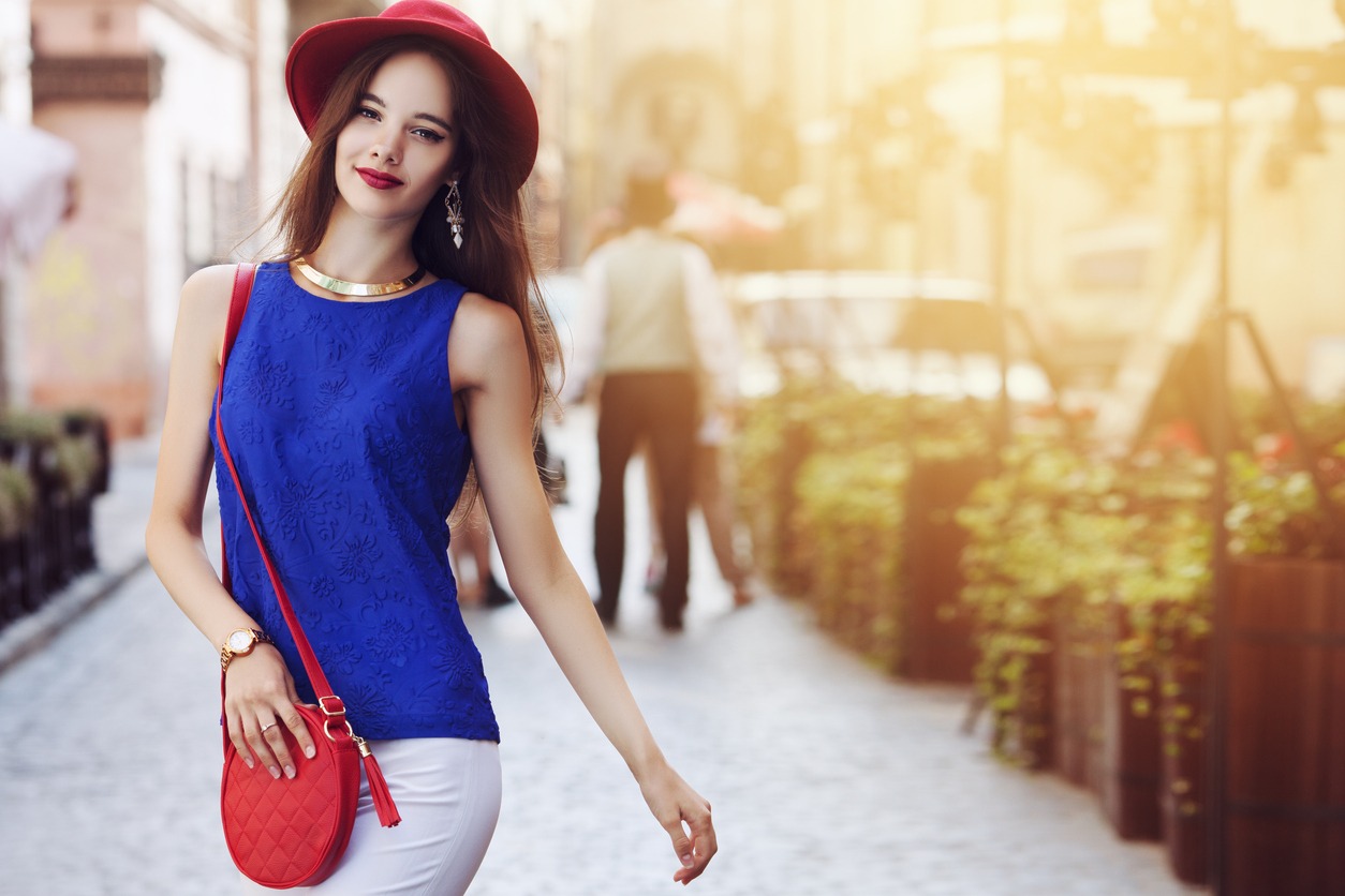 woman carrying a red sling bag