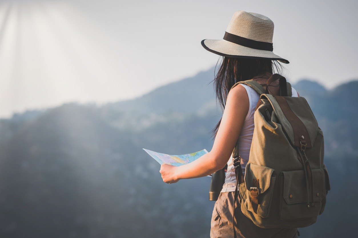 A woman outdoors wearing a backpack