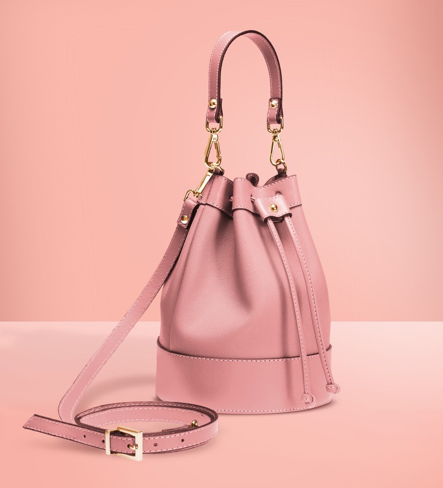 Fashion photography, pink color designer bucket bag on a pastel pink background with clipping path